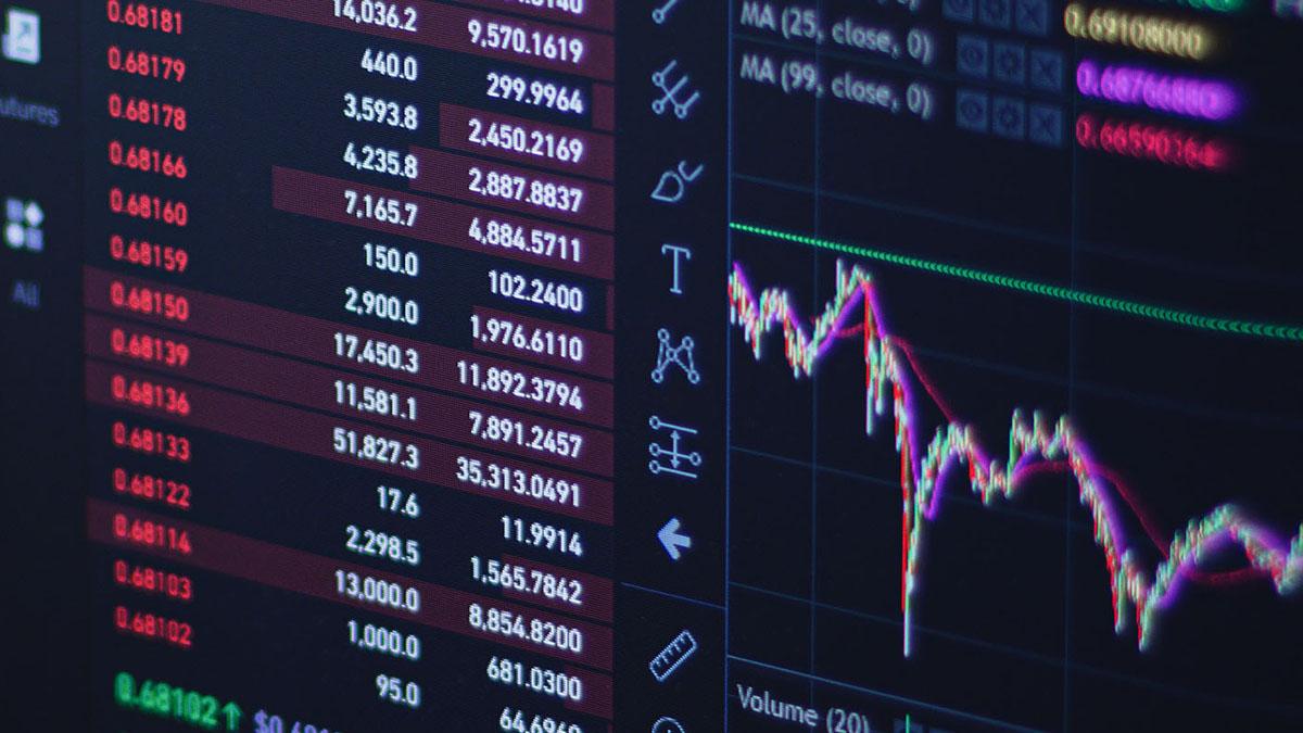 Photo of computer with stock graphs