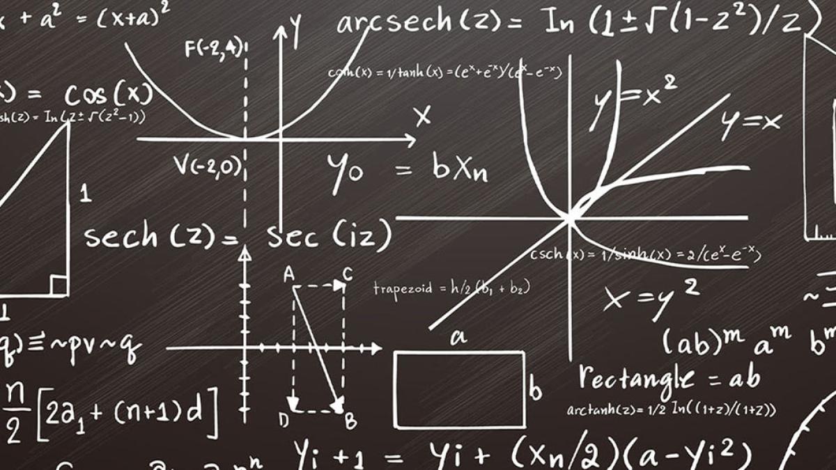 Mathematical equations on a black chalkboard