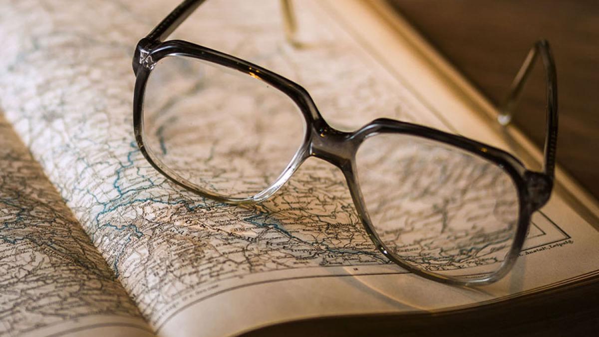 Glasses resting on a map almanac