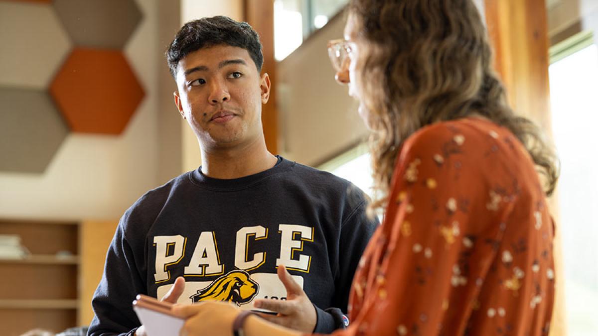 Student speaking to a Pace staff member.