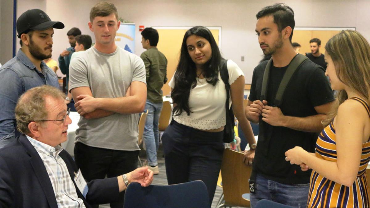Pace University students networking with a business leader in the Entrepreneurship Lab