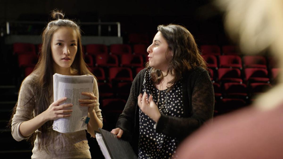Directing alumna leading a female student in a scene