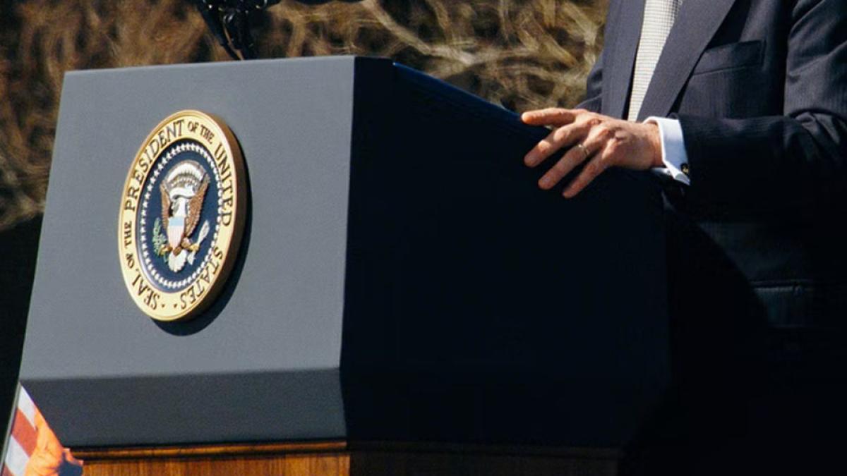 Individual standing at the President of the United States podium