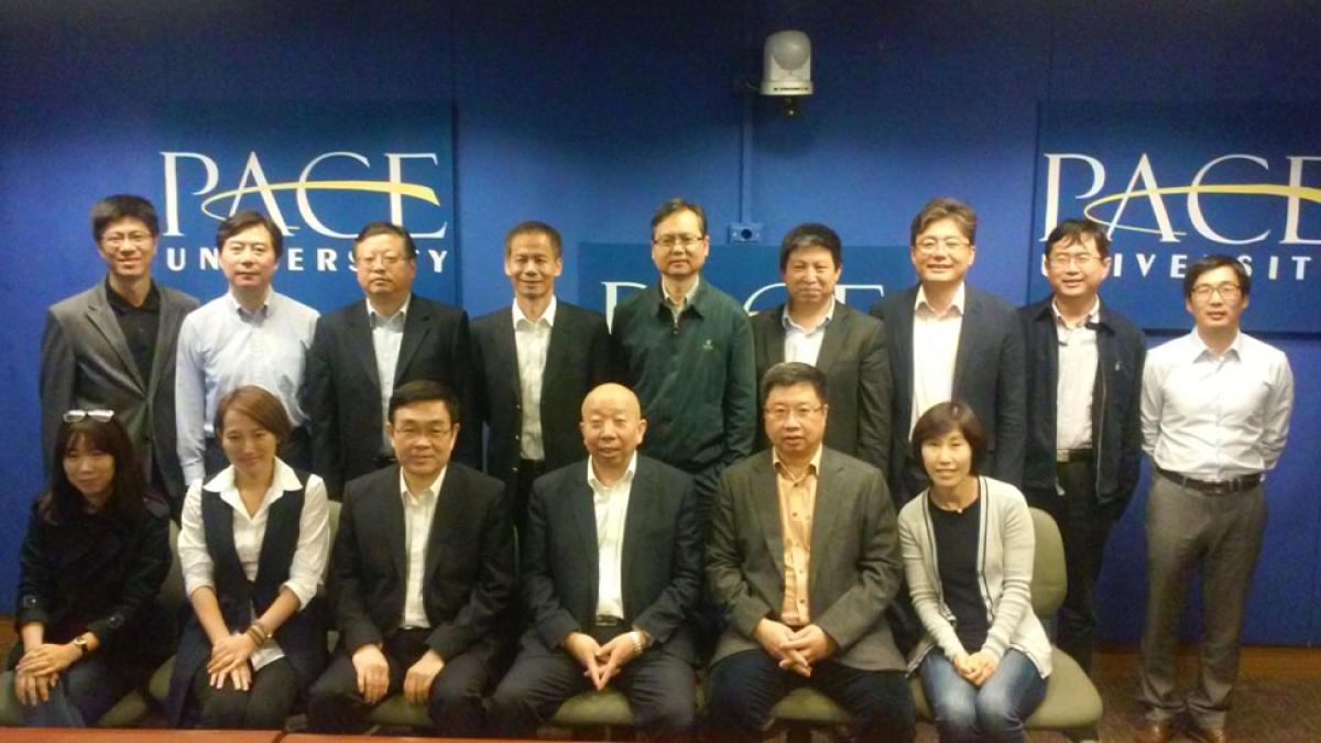 International group of publishers infront of the Pace University logo