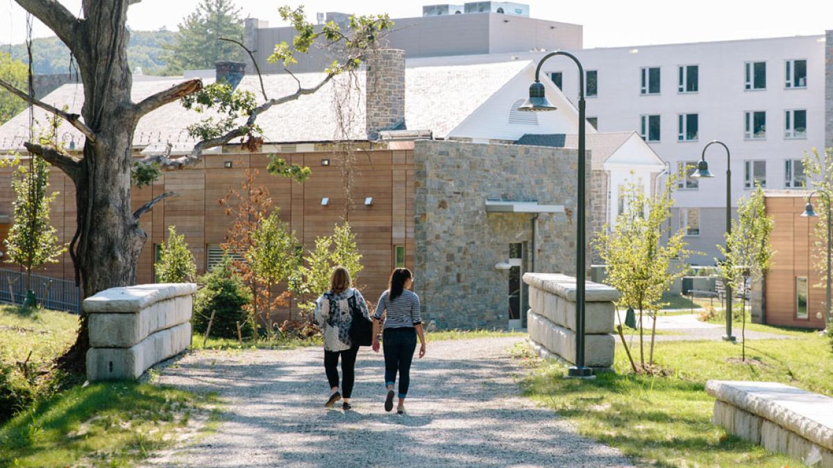 two Pace University students walking on a path at the Pleasantville Campus of Pace University