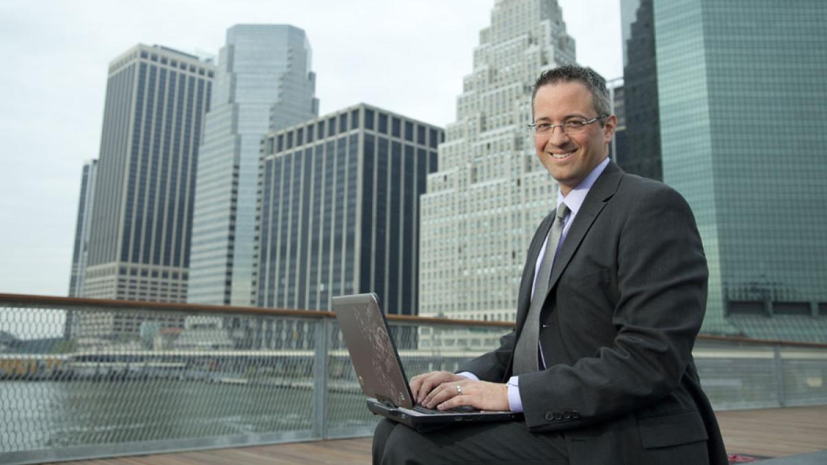 man in business attire sitting in Lower Manhattan near Pace University's New York City Campus