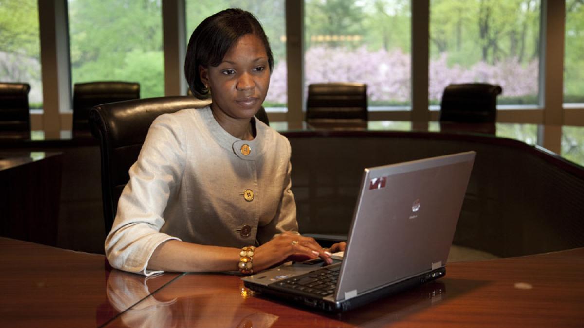 Lubin student sitting at a laptop in a student lounge on the Pleasantville Campus