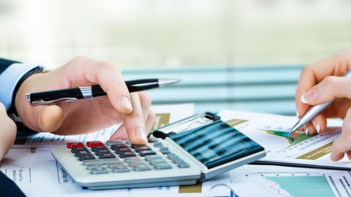 accounting department - two people doing accounting with papers and calculators