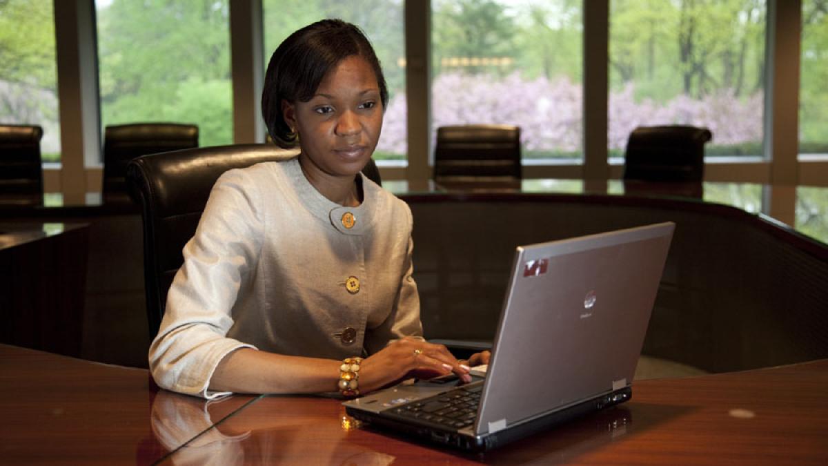 Lubin student sitting at a laptop in a student lounge on the Pleasantville Campus