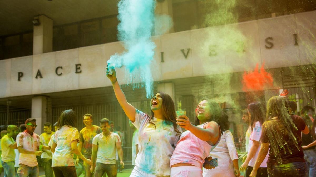 group of people throwing colored powder