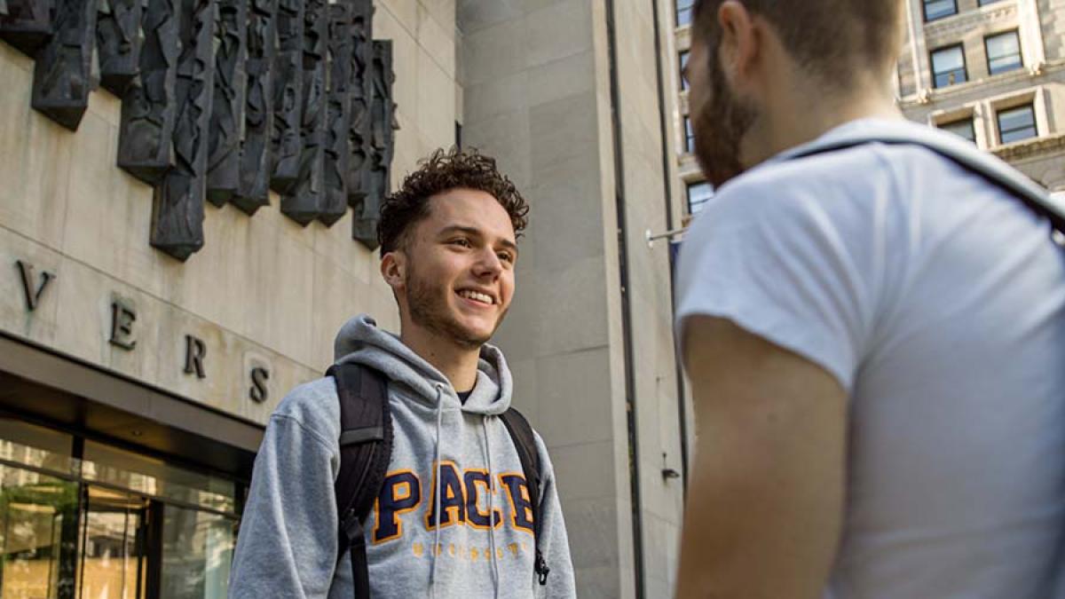 two male students talking in front of One Pace Plaza