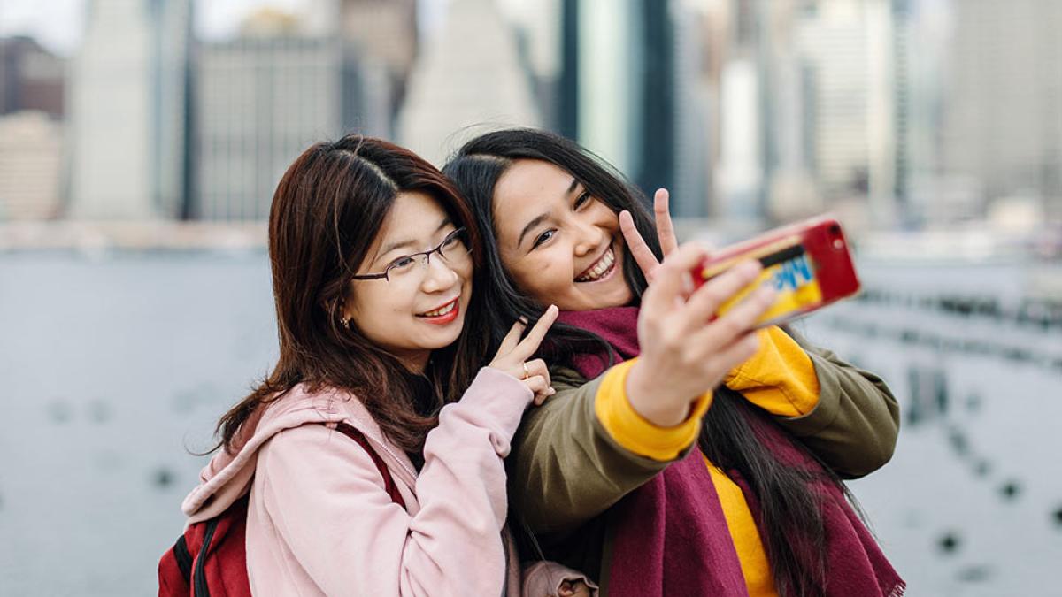 Two female pace students taking a selfy on the Brooklyn Bridge