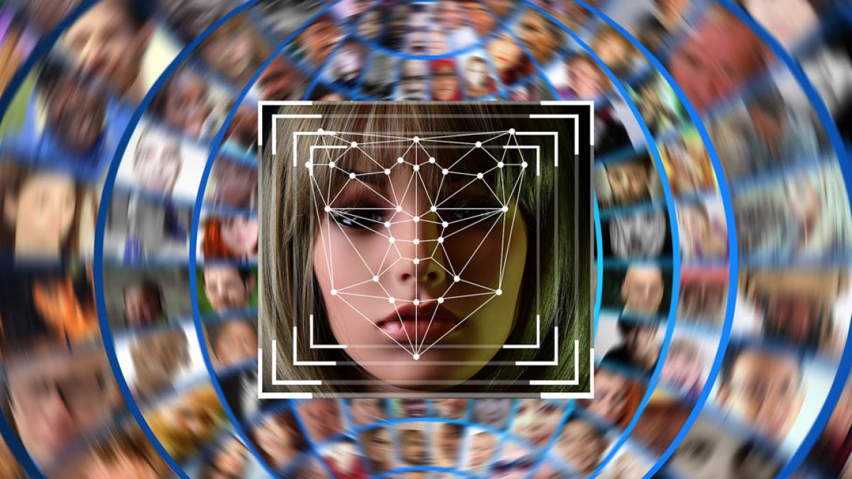 abstract graphic of human face and computer screens representing "facial recognition'