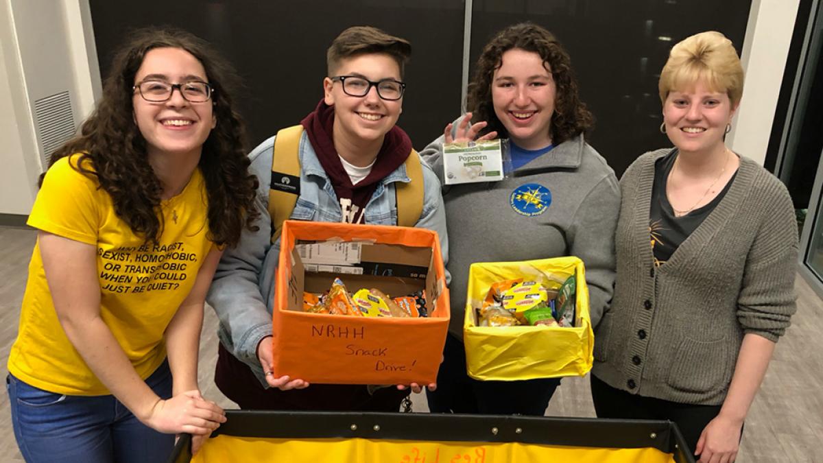 McGinley and other volunteers pose with collected food items