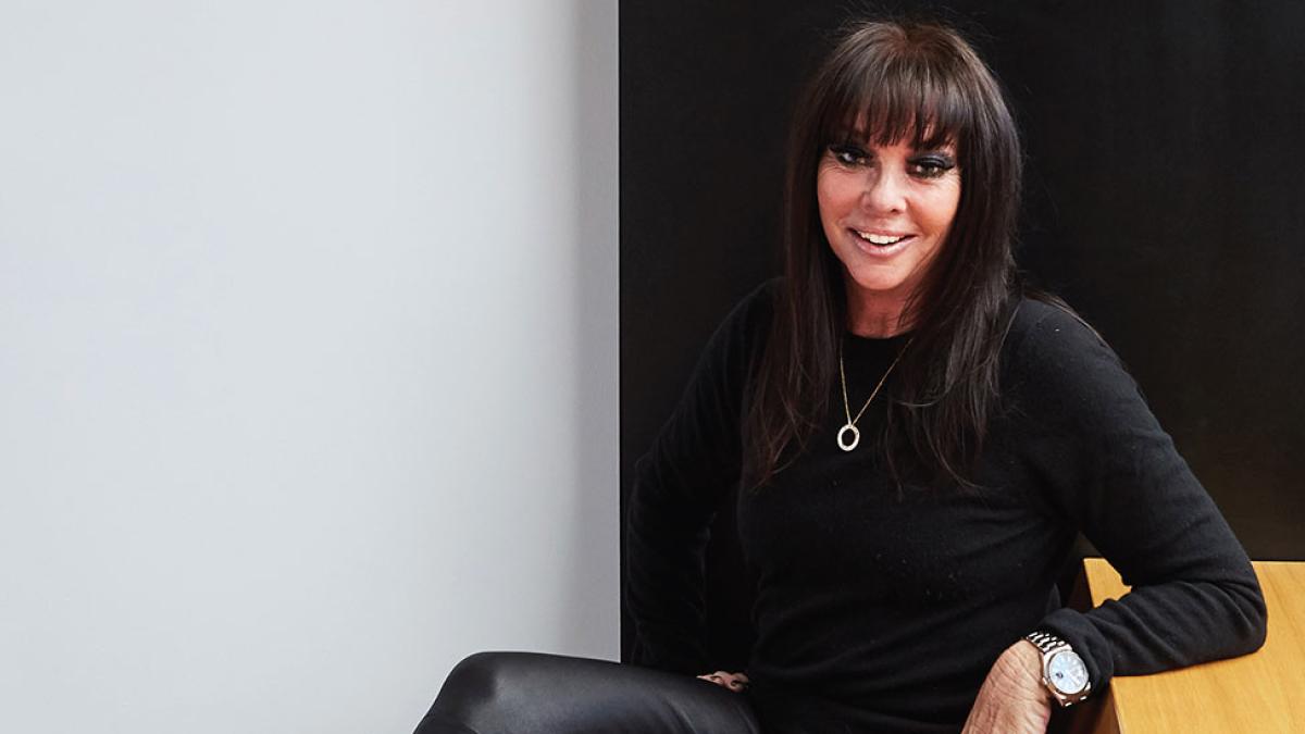 woman in black sweater smiling at camera