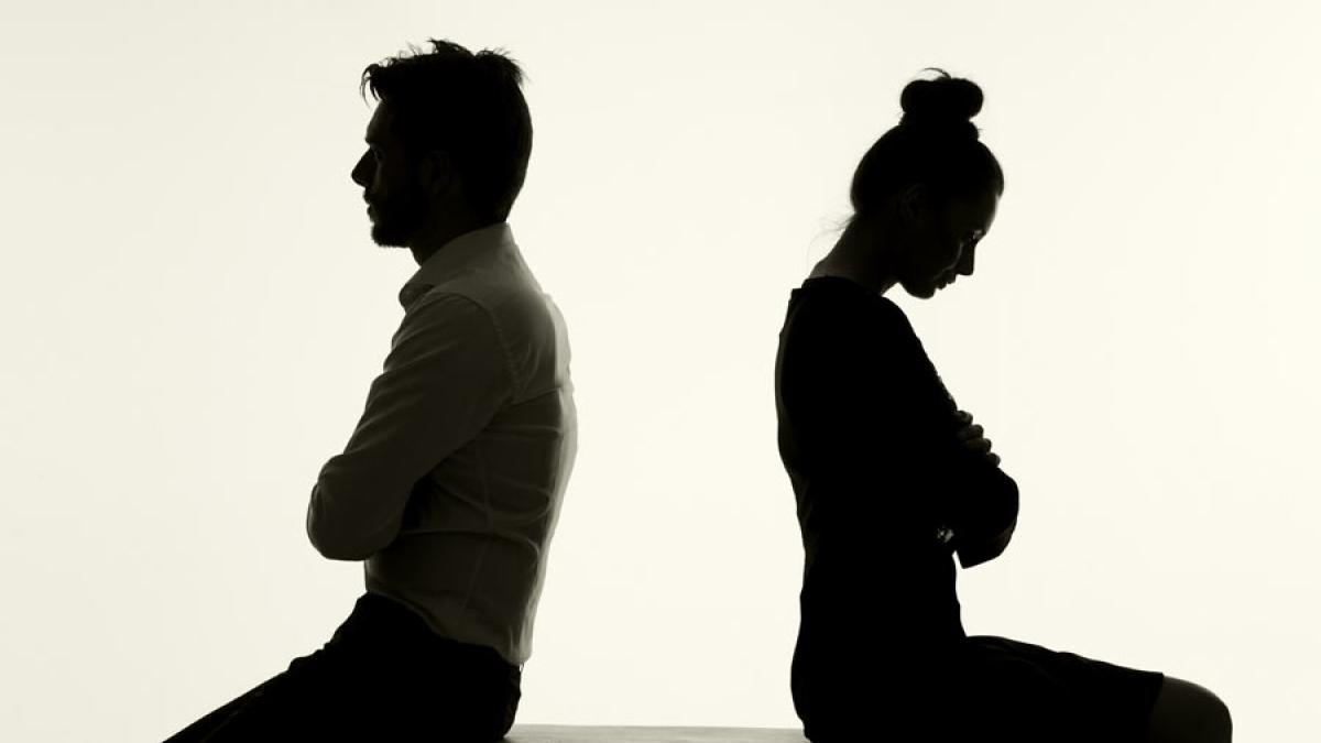 silhouette of two people disagreeing