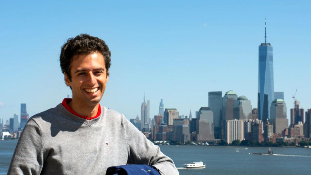 Lubin student Manuel Crugliano '22 in Brooklyn with view of Lower Manhattan skyline