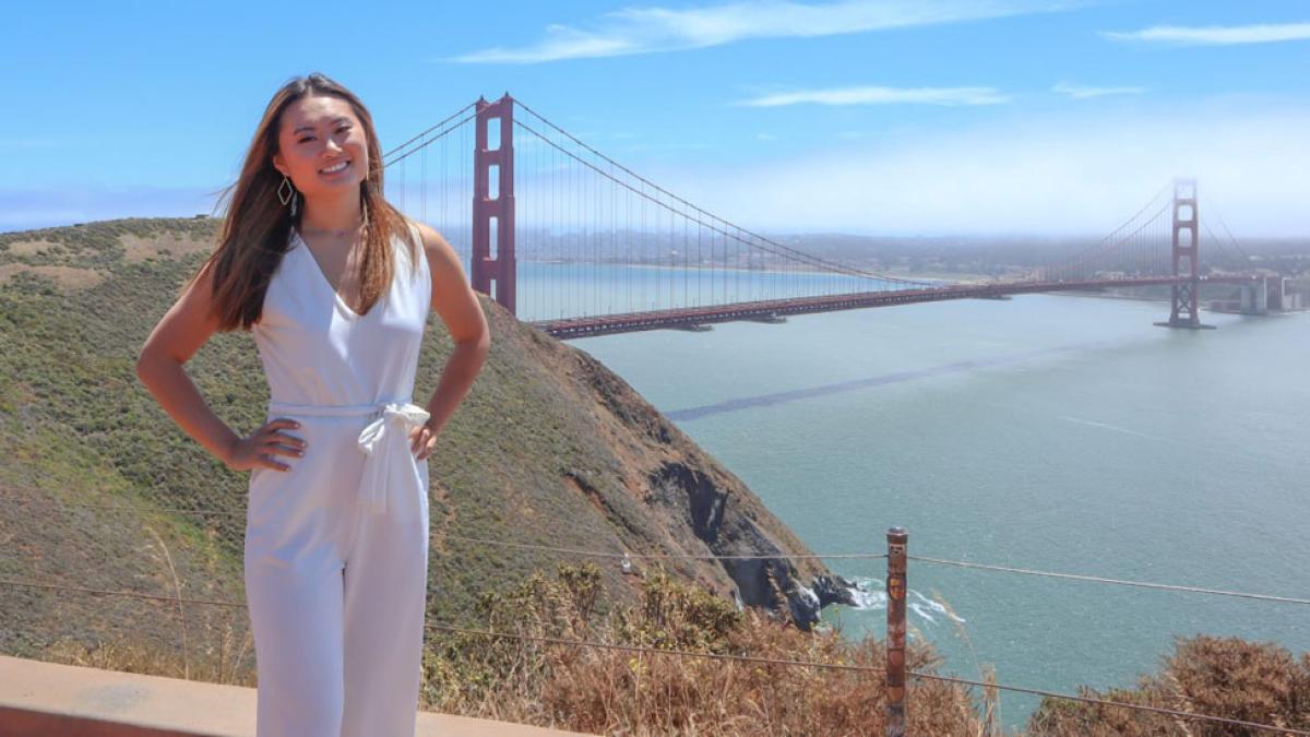Lubin student Christal Wong '22 standing in front of the Golden Gate Bridge in California