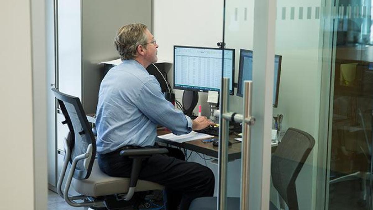 Staff member working on his computer.