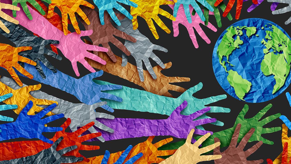 construction paper hands reaching for a globe