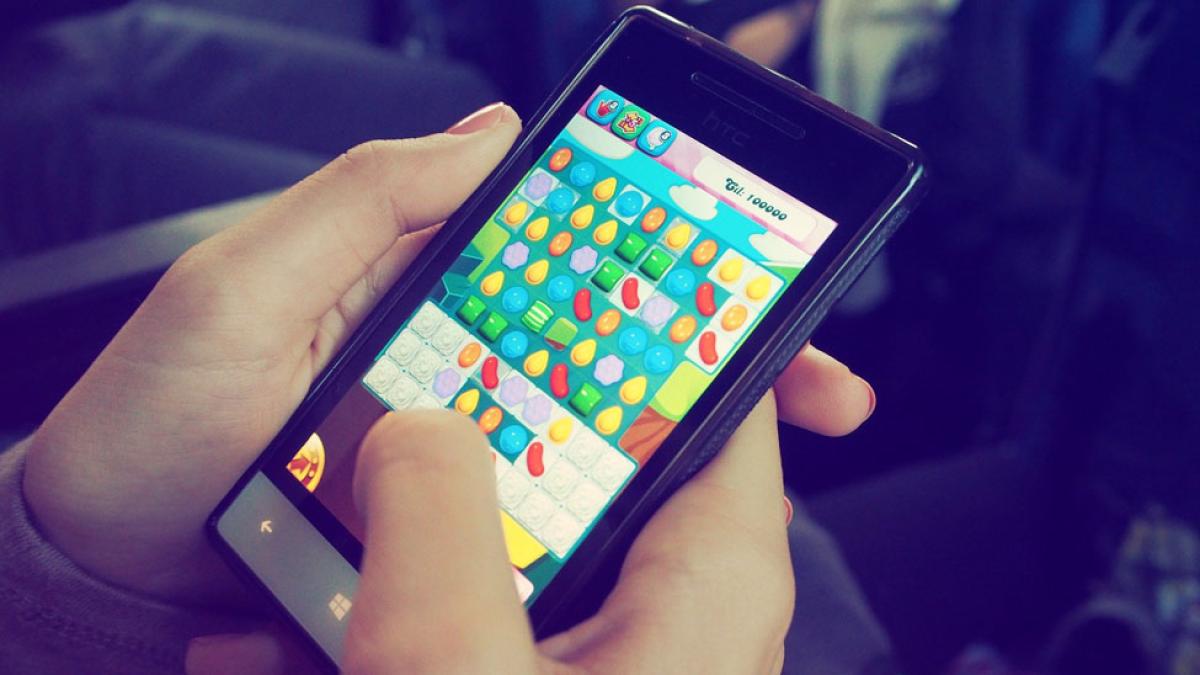 hands holding a mobile phone with an online game