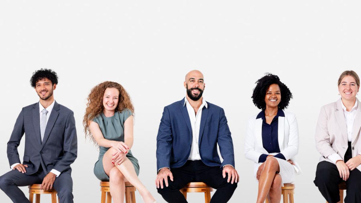 group of seated people in business attire representing the idea of "about us"