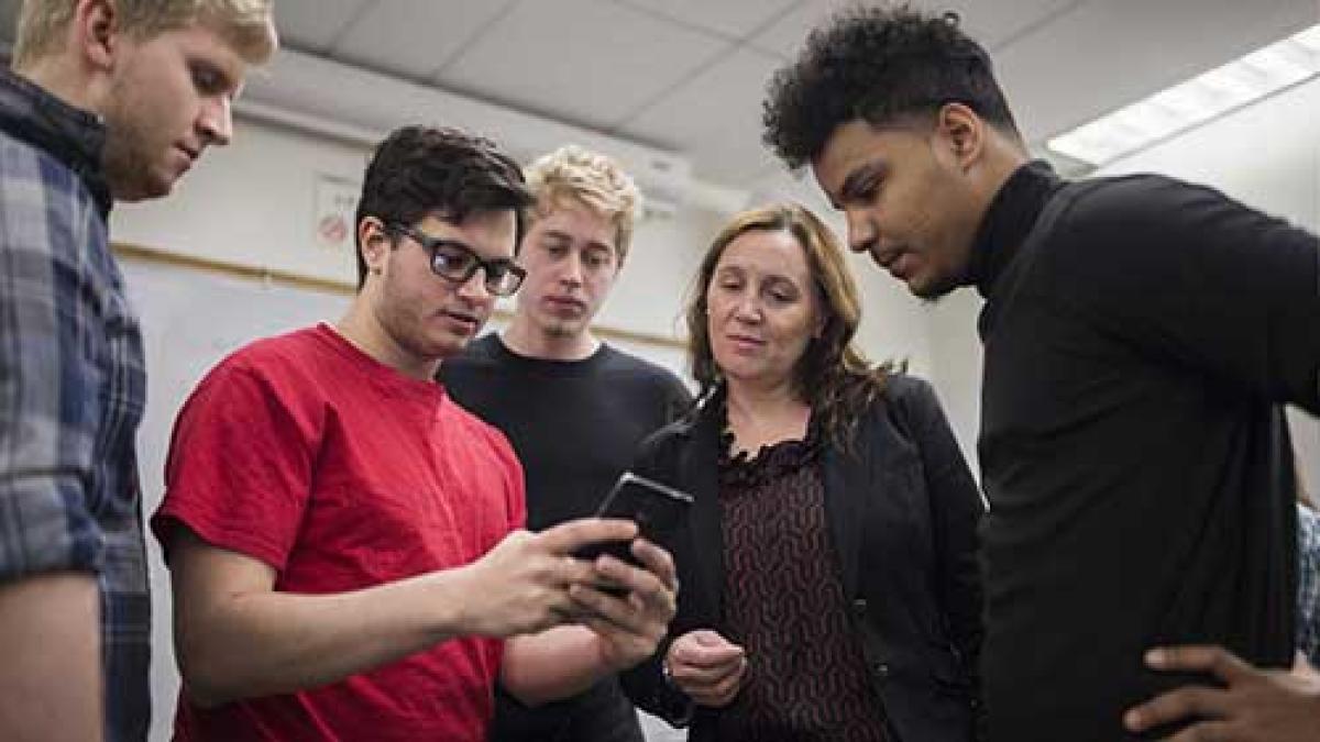 group of male students and a female professor