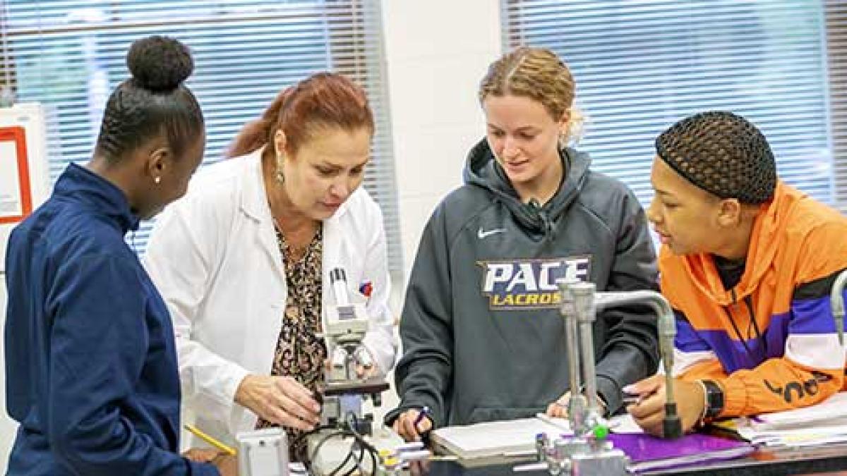 students and faculty working in a lab