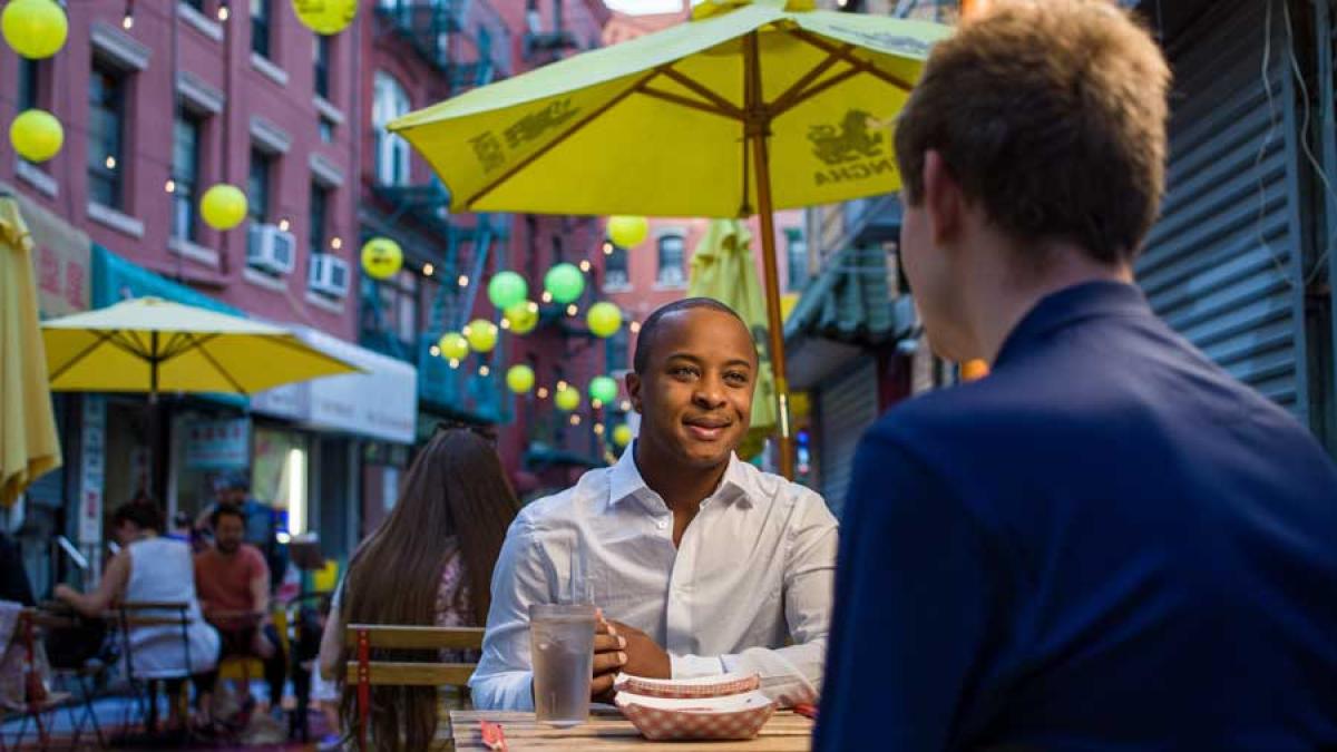 Two Pace students conversing at restaurant outside in Manhattan