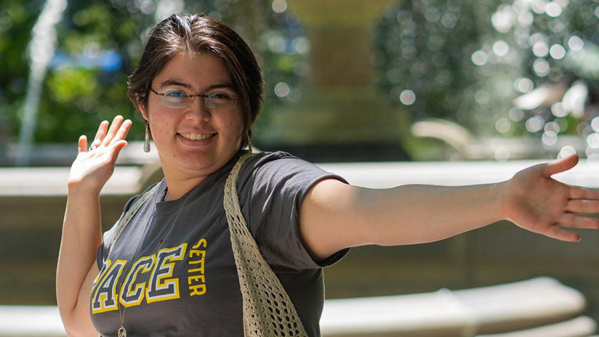 person smiling with arms outstretched