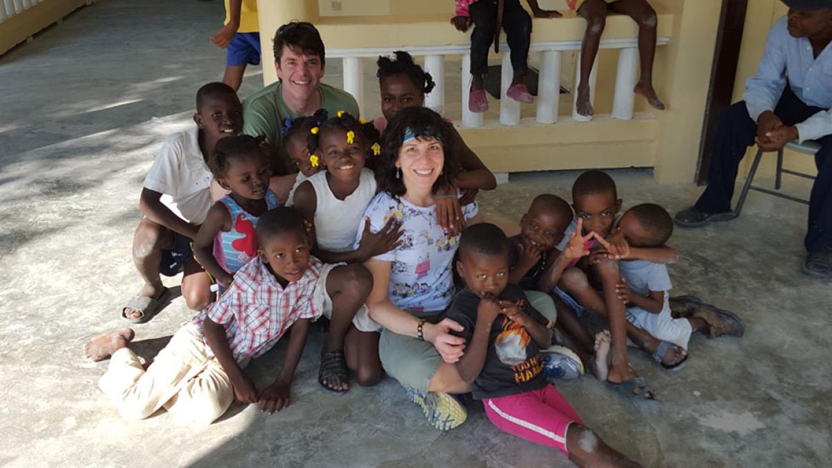 woman sitting with group of children