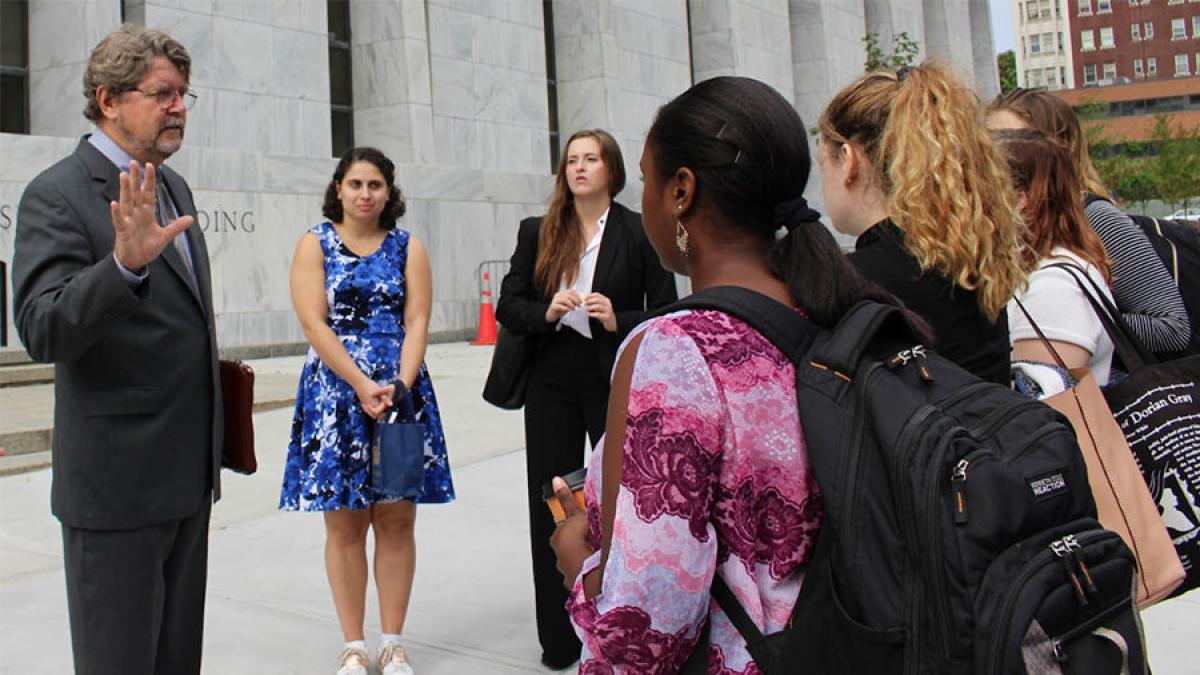 group of students looking at man in suit