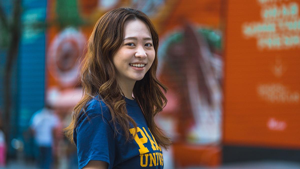 Hinako Tanakamaru faces the camera wearing a blue and gold Pace t-shirt