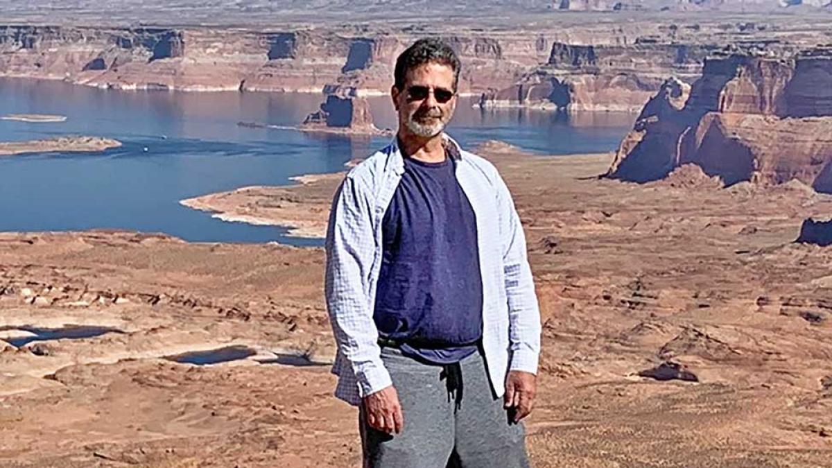 David Cassuto with a scenic background - a river and a dry, open landscape