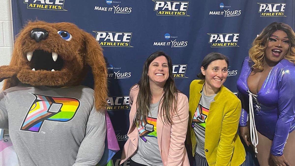 Pace mascot and students celebrating pride hoops night