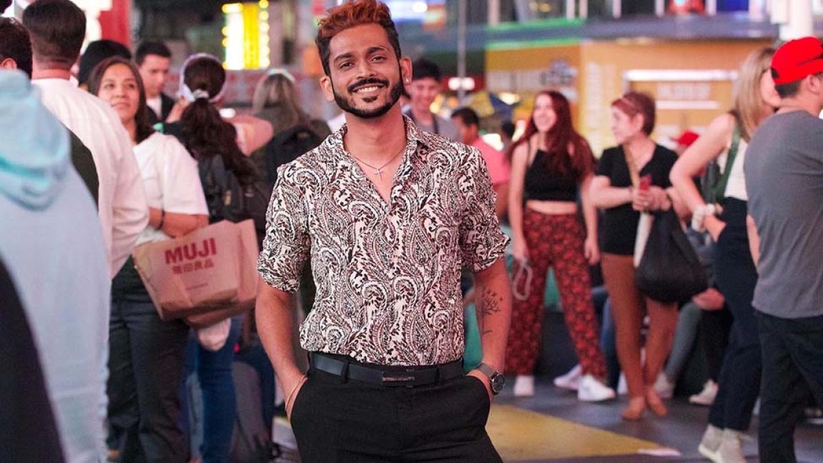 Chinmay Bonde, wearing a colorful shirt, stands in a crowd