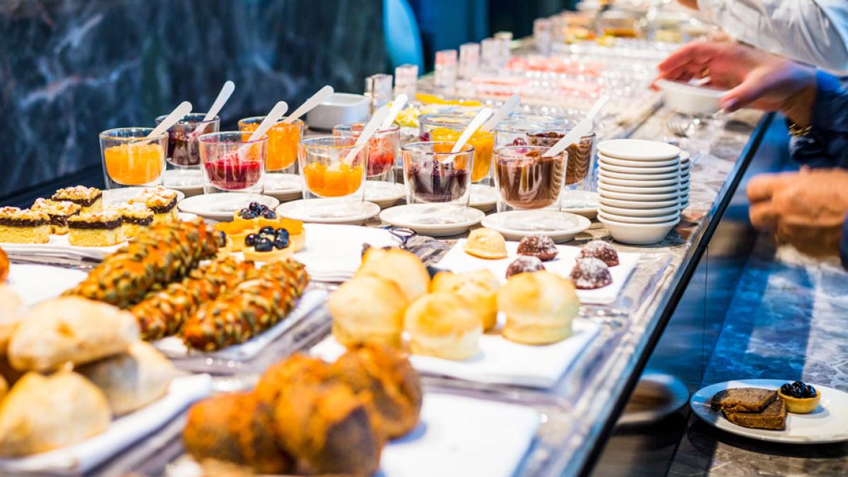 people taking items from breakfast buffet