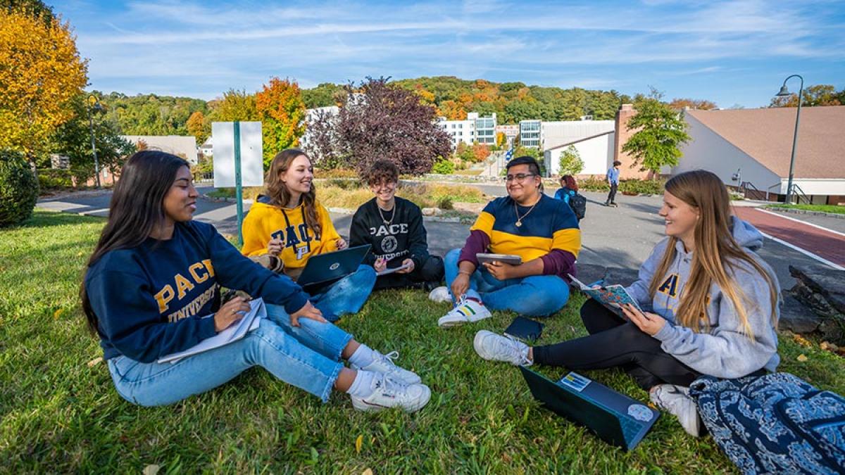 Pace students on Pleasatville Campus sitting in circle on campus lawn.