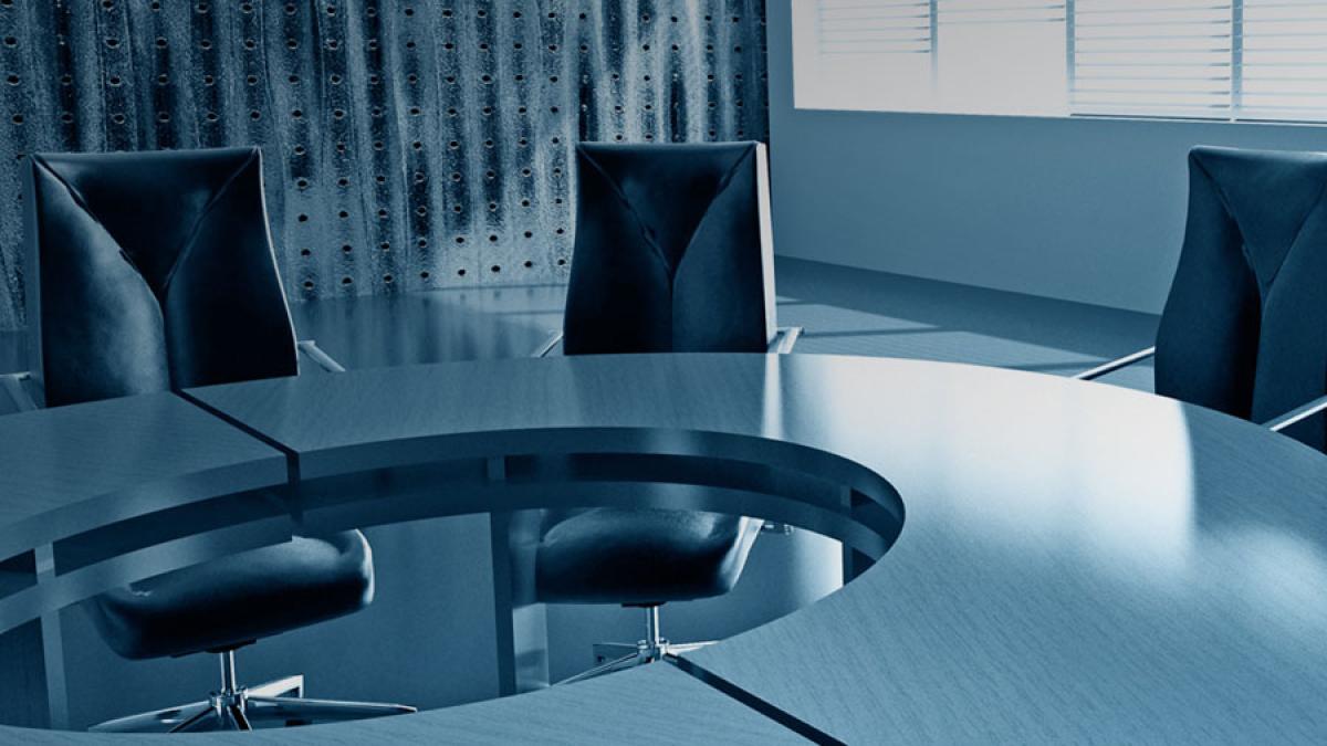 round table in meeting room with three chairs