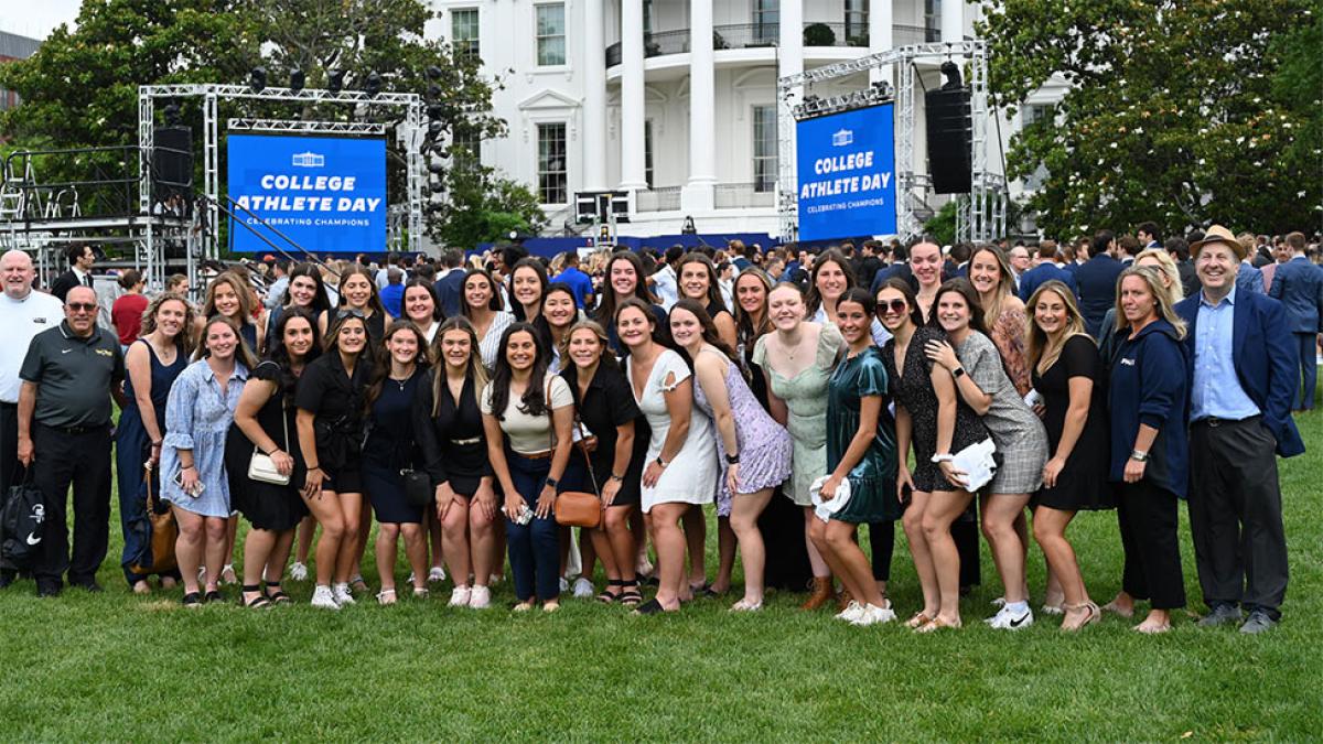 Womens lacrosse team from Pace University posing at the white house. 