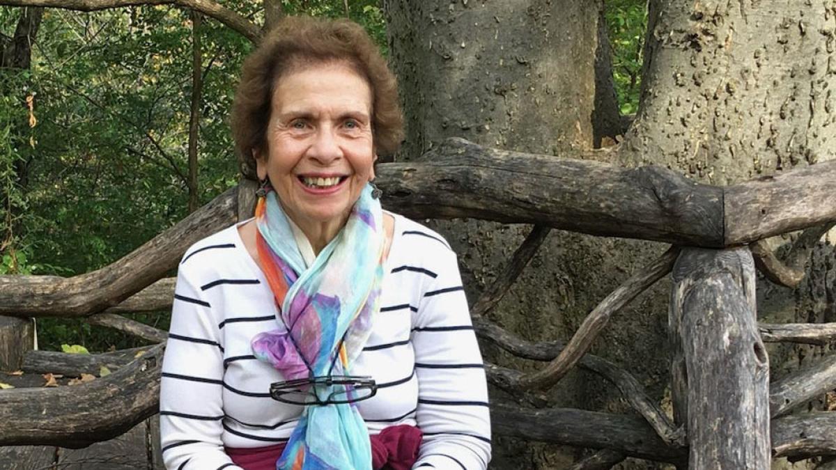 marilyn jaffe-ruiz sitting on a bench and posing for the camera. 