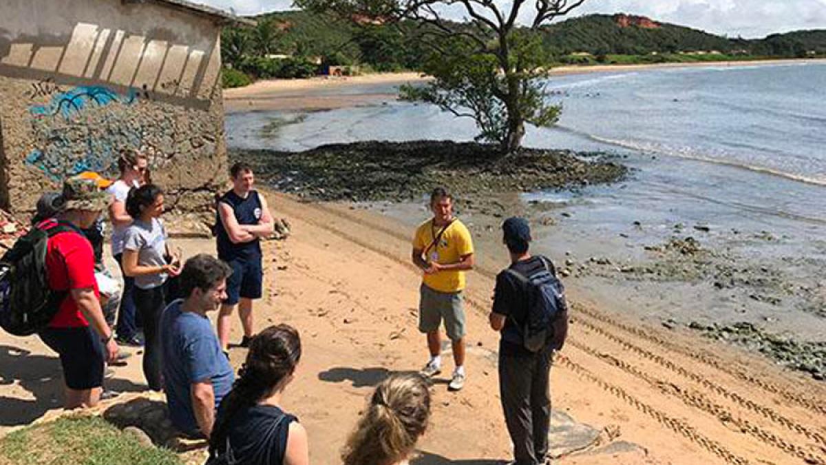 Elisabeth Haub School of Law professor speaking with students on a beach