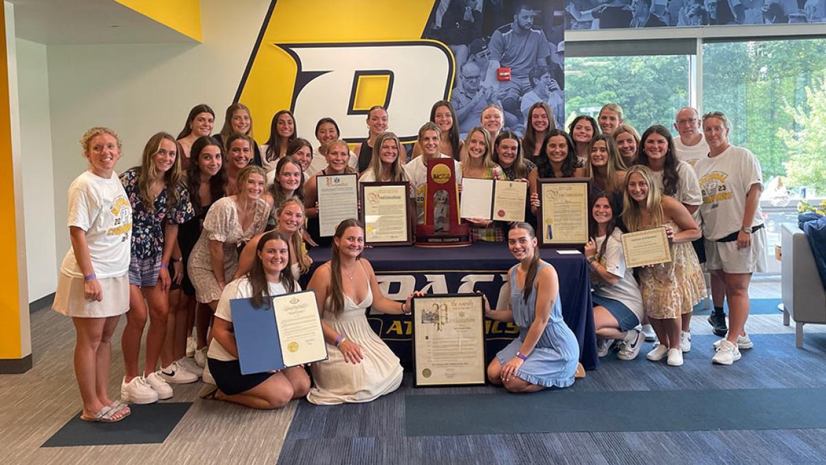Pace University National Champion Women's Lacrosse team posing with awards