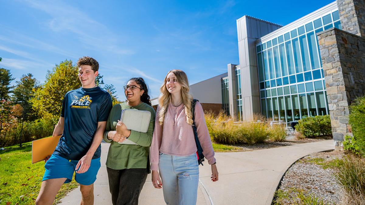 3 Pace University students walking away from the Kessel Student Center