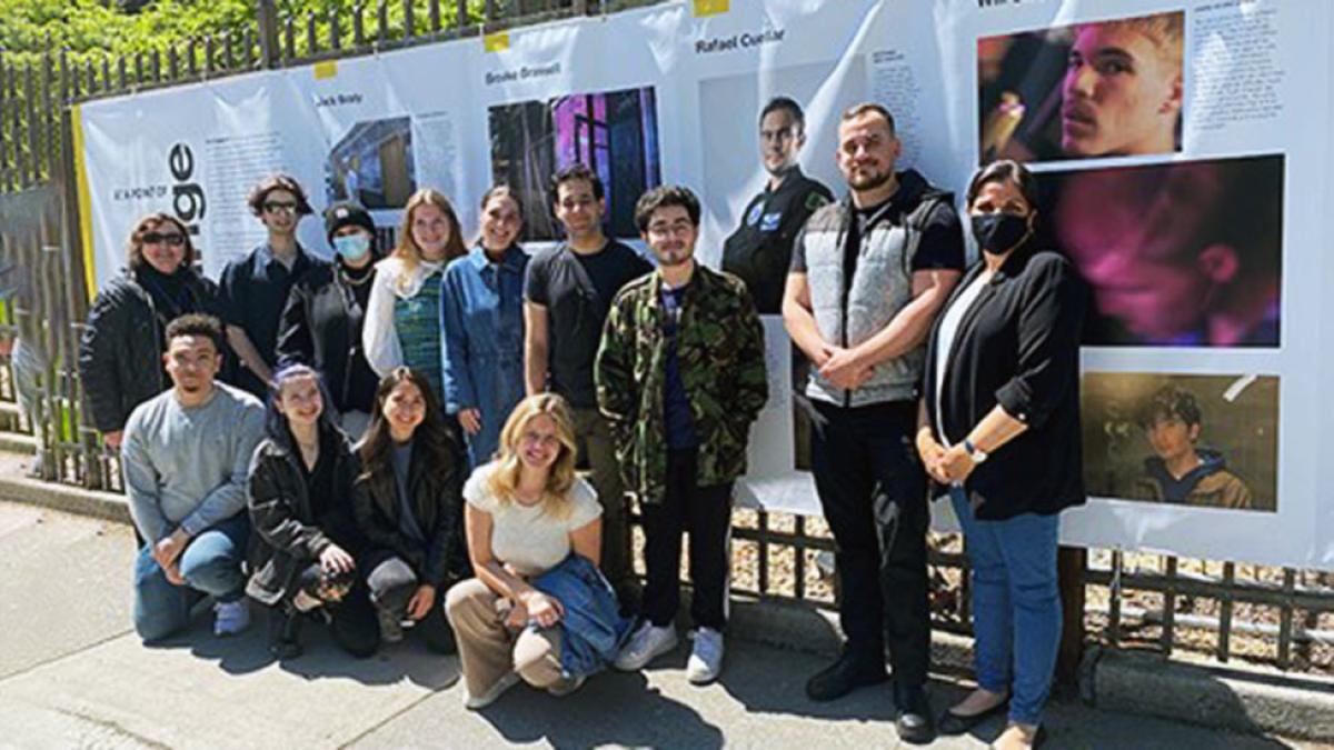 Group of Pace University economics students standing in front of posters