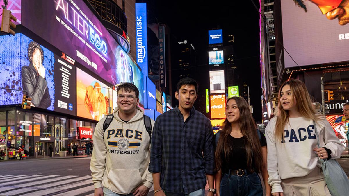 pace students in times square at night