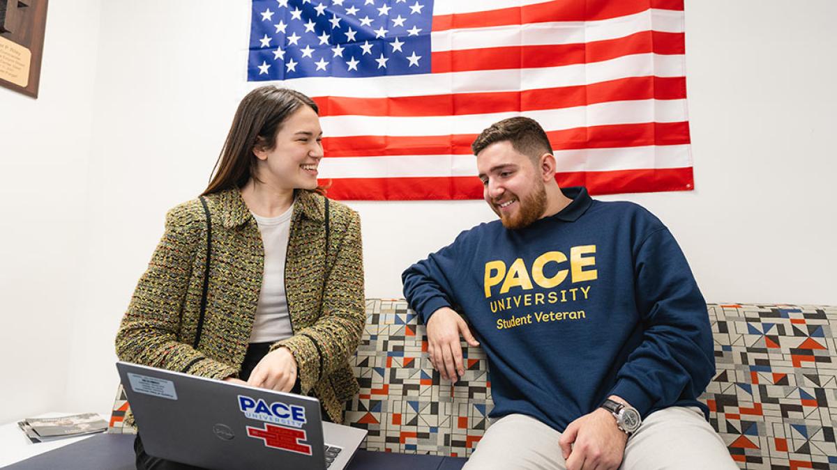 Pace students sitting around a desk meeting.