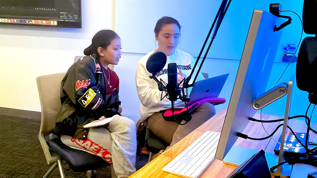 Pace University's Writing for Diversity and Equity in Theater and Media students working on a podcast at a computer