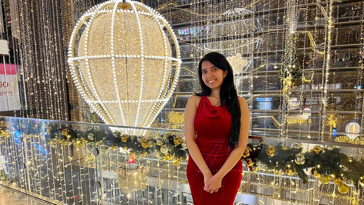 Pace student Hitasha Nagdeo stands in front of a holiday display in New York City 