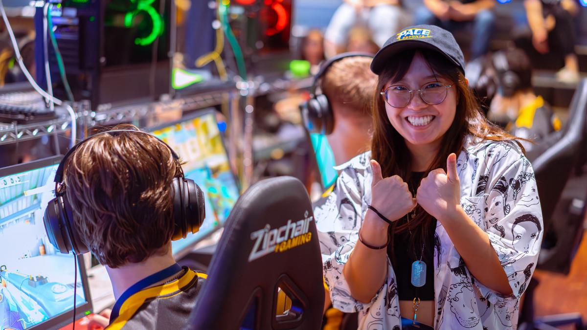 Pace University student, Julia Cardillo gives the thumbs up next to a Pace Esports athlete 
